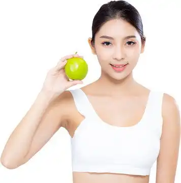 图源免费下载大图亚洲女性微笑手持青苹果且身材优美的肖像人像东方女性运动健身高清图片