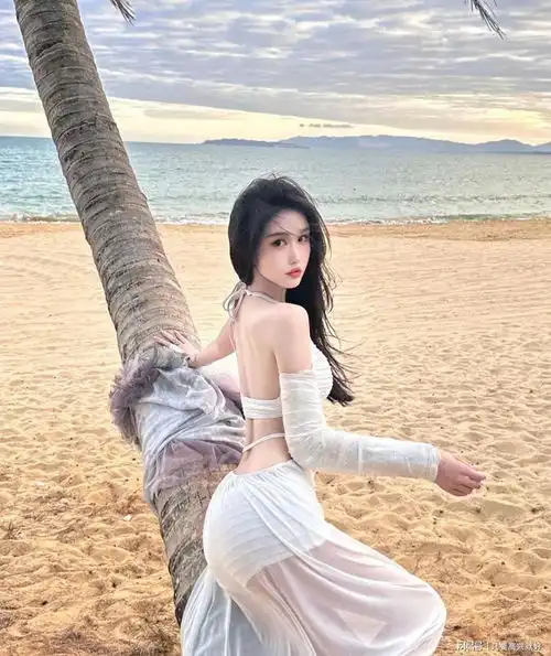 美女穿上白色时尚的经典泳装,在海边就是经典的靓丽风景